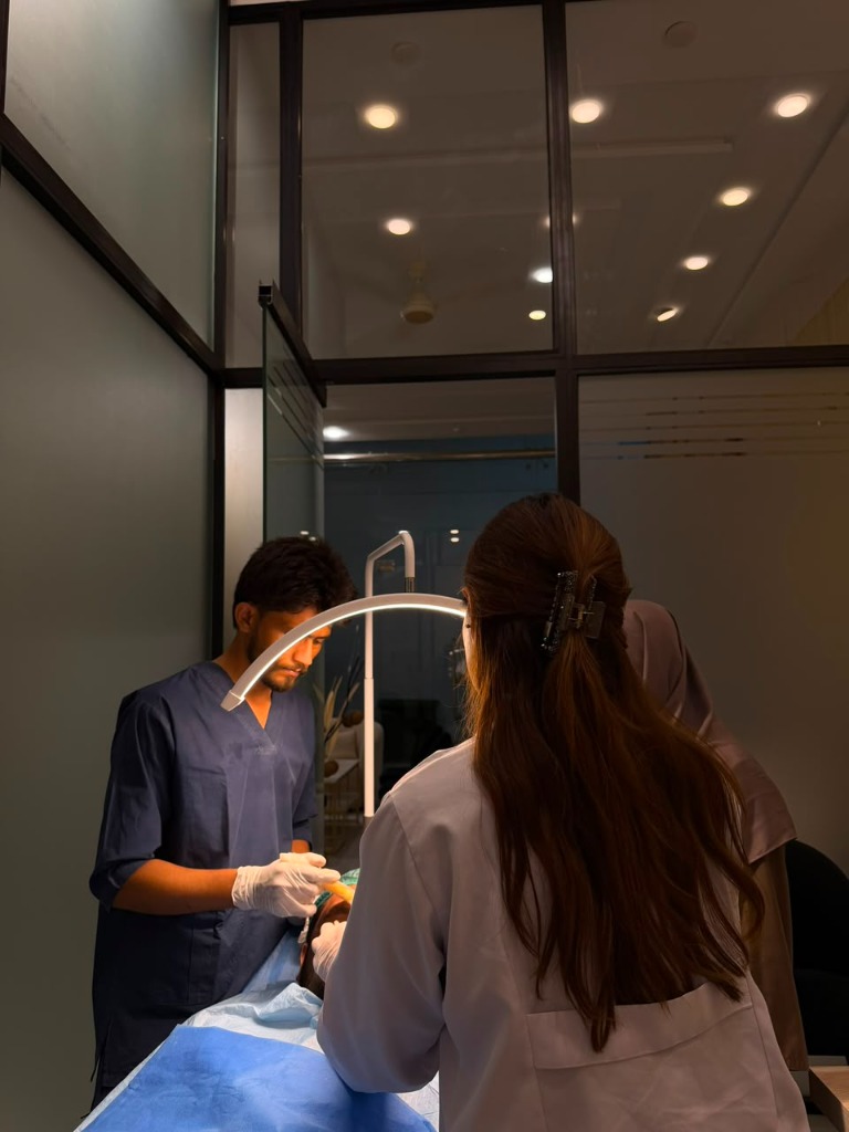 Dr Farah Iqbal performing aesthetic procedure at clinic